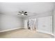 Large bedroom with neutral carpet, ceiling fan, and access to staircase, bathroom, and closet at 1618 Durden Ne Rd, Atlanta, GA 30319