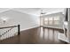 Upstairs bonus room with hardwood floors, fireplace, natural light, and stairway at 1618 Durden Ne Rd, Atlanta, GA 30319