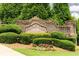 Stone entrance sign for The Reserve at Brookleigh, surrounded by lush landscaping and mature trees at 1618 Durden Ne Rd, Atlanta, GA 30319