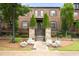 Charming brick townhome featuring a landscaped yard and wrought iron fence at 1618 Durden Ne Rd, Atlanta, GA 30319