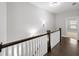 Bright hallway featuring hardwood floors, a wooden staircase, and white walls at 1618 Durden Ne Rd, Atlanta, GA 30319