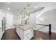 Open kitchen featuring island with seating, stainless steel appliances and dark hardwood floors at 1618 Durden Ne Rd, Atlanta, GA 30319