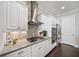 Modern kitchen features white cabinetry, stainless steel appliances, and a stylish backsplash at 1618 Durden Ne Rd, Atlanta, GA 30319