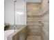 Close-up of a beautifully tiled shower with stone pebble floor and a glass enclosure at 1618 Durden Ne Rd, Atlanta, GA 30319
