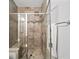 Beautiful glass-enclosed shower with tiled walls, a built-in seat, and modern fixtures at 1618 Durden Ne Rd, Atlanta, GA 30319