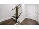 Elegant staircase with dark wood steps, white risers and banisters, and a wood handrail at 1618 Durden Ne Rd, Atlanta, GA 30319