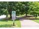 Community walking path sign with view of paved path and surrounding mature trees at 1618 Durden Ne Rd, Atlanta, GA 30319