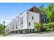 Modern townhome exterior with white siding, black accents, and manicured landscaping offers curb appeal at 1645 Overlook Nw Way # 9, Atlanta, GA 30318