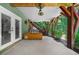 Charming back porch with a hot tub, double doors leading inside, and wooded views at 4020 High Gables E, Cumming, GA 30041