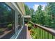 Relaxing deck area with planters and a view of the wooded surroundings at 4020 High Gables E, Cumming, GA 30041