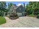 Charming two-story home showcasing a two-car garage and well-manicured landscaping at 4020 High Gables E, Cumming, GA 30041