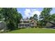 Charming two-story home with a manicured lawn, lush landscaping, and inviting front porch at 4020 High Gables E, Cumming, GA 30041