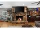 Cozy living room fireplace with stone surround, wooden mantle, and custom cabinets at 4020 High Gables E, Cumming, GA 30041