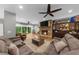 Bright open concept living room features a stone fireplace, hardwood floors, and comfortable seating at 4020 High Gables E, Cumming, GA 30041