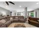 Open living space with a large sectional sofa, hardwood floors, and an open layout into the kitchen at 4020 High Gables E, Cumming, GA 30041