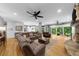 Open living space with a large sectional sofa, hardwood floors, and an open layout into the kitchen at 4020 High Gables E, Cumming, GA 30041