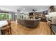 Bright open concept living room features a stone fireplace, hardwood floors, and a large comfy sectional sofa at 4020 High Gables E, Cumming, GA 30041