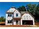 Unfinished two-story home with visible stud framing and a two-car garage awaiting completion at 502 Charleston Pl, Villa Rica, GA 30180
