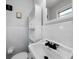 Bright bathroom features white tile, storage cabinet, updated sink and matte black faucet at 506 Bolijeri Blvd, Villa Rica, GA 30180