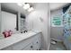 Bathroom featuring a white vanity with stone countertop and butterfly-themed decor at 506 Bolijeri Blvd, Villa Rica, GA 30180
