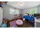 bedroom with toys, wood floors, and double windows offering natural light at 506 Bolijeri Blvd, Villa Rica, GA 30180