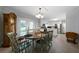 Open dining room and kitchen with white cabinets, stainless steel appliances, and backyard access at 506 Bolijeri Blvd, Villa Rica, GA 30180
