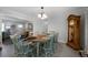 Open dining room with adjacent living area and vintage grandfather clock at 506 Bolijeri Blvd, Villa Rica, GA 30180