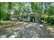 Picture of the home with a light blue painted brick facade, covered carport, and spacious driveway at 506 Bolijeri Blvd, Villa Rica, GA 30180