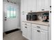 Kitchen featuring lots of white cabinetry, countertop appliances, and door to the backyard at 506 Bolijeri Blvd, Villa Rica, GA 30180