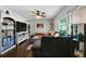 Bright living room featuring hardwood floors, a comfortable sofa, and large window with natural light at 506 Bolijeri Blvd, Villa Rica, GA 30180