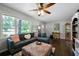 Bright living room with hardwood floors, an L-shaped sofa, and natural light, creating a warm atmosphere at 506 Bolijeri Blvd, Villa Rica, GA 30180