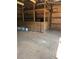 View of the horse stall, propane tanks, wood walls and dirt floor inside the barn at 393 W Freeman St, Maysville, GA 30058
