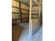 Barn interior, featuring wood-paneled walls, dirt floor, and a metal roof at 393 W Freeman St, Maysville, GA 30058