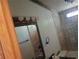 Simple bathroom with tiled shower, vanity with lighting, and neutral finishes at 393 W Freeman St, Maysville, GA 30058