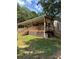 Charming house featuring a large covered porch and natural wood accents, set in a serene, wooded environment at 393 W Freeman St, Maysville, GA 30058
