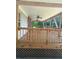 Spacious covered porch with natural wood railings and ceiling fans, perfect for outdoor relaxation and entertaining at 393 W Freeman St, Maysville, GA 30058