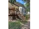 Exterior stairway leading to a covered porch, with a wood railing and lattice skirting at 393 W Freeman St, Maysville, GA 30058