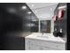 Sleek bathroom vanity with black accent wall, herringbone shower, and modern fixtures at 145 15Th Ne St # 826, Atlanta, GA 30309