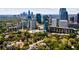 Expansive city view featuring modern buildings surrounded by trees under a blue sky with scattered clouds at 145 15Th Ne St # 826, Atlanta, GA 30309