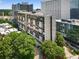 High angle view of a modern apartment complex in an urban setting with surrounding green trees at 145 15Th Ne St # 826, Atlanta, GA 30309