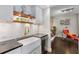 Well-lit kitchen with subway tile backsplash, open wood shelving, and a stylish farmhouse sink at 145 15Th Ne St # 826, Atlanta, GA 30309