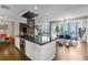 Spacious kitchen with black countertops, a central island, and an open layout to the dining area at 145 15Th Ne St # 826, Atlanta, GA 30309
