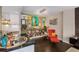 Eclectic living room adjacent to kitchen with art-filled wall, an accent chair, and bookshelf at 145 15Th Ne St # 826, Atlanta, GA 30309