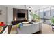 Bright living room showcasing a curved sofa, media center, and large windows with city views at 145 15Th Ne St # 826, Atlanta, GA 30309