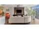 Modern living room featuring a curved sofa, mounted TV, wood floors, and city views through large windows at 145 15Th Ne St # 826, Atlanta, GA 30309
