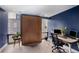 Contemporary home office with built-in Murphy bed, desk, and large windows overlooking city at 145 15Th Ne St # 826, Atlanta, GA 30309