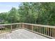 Spacious back deck with wooden flooring, offering a serene view of the surrounding trees at 1618 Chancery Ln, Lithia Springs, GA 30122