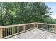 Wide angle photo of a roomy back deck overlooking lush greenery at 1618 Chancery Ln, Lithia Springs, GA 30122