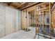 Basement space with concrete walls, exposed beams, and utility connections at 1618 Chancery Ln, Lithia Springs, GA 30122