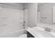 Bathroom featuring a shower-tub combo and a sink with modern faucet at 1618 Chancery Ln, Lithia Springs, GA 30122